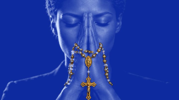 Woman 2 of 13 in prayer, wearing Rosario N°01